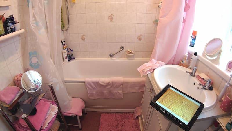 Pink bathroom with bath and curtains