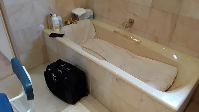 Bath with sheets in it black bag on the side